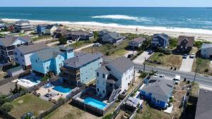 an aerial view of a beach with houses and the ocean at The Sandbox in Kill Devil Hills
