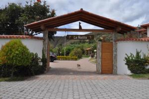 Lujosa Quinta Vacacional Ibarra في إيبارا: مدخل لمبنى عليه لافته