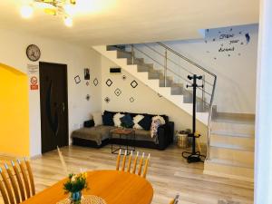 a living room with a couch and a staircase at Casa Sofia in Călimăneşti +85 photos