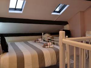 a bedroom with a bunk bed with skylights at Cockleshell Cottage in Cockermouth