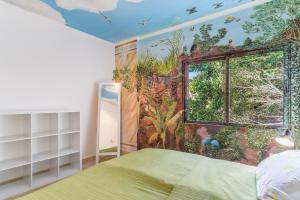 a bedroom with a painting on the wall at Reis Magos Apartment by HR Madeira in Caniço