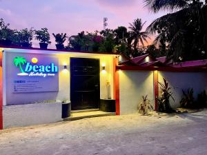 a building with a beach party sign on it at Thoddoo Beach Holiday Inn in Thoddoo