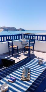 a table and two chairs sitting on a boat at Pasithea Villa Finiki in Foiníkion