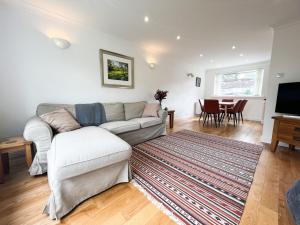 a living room with a couch and a tv and a table at Home away from home Milngavie in Milngavie