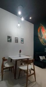a dining room with a table and two chairs at Wifi 100Mbps+Netflix - Wau Bulan Flies @ The CEO in Bayan Lepas