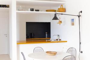 a kitchen with a white table and chairs at Beach hideaway apartment with modernist design in Santa Cruz de Tenerife