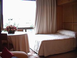 Кровать или кровати в номере Apartment Plaza de Pradollano