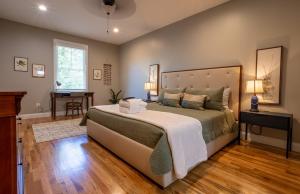 a bedroom with a large bed and a desk at The Sunny Side in Asheville