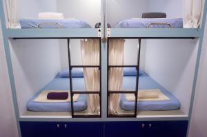 a group of bunk beds in a room at Sojourn Beds & Cafe in Taiping +82 photos