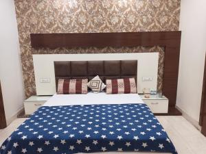 a bedroom with a bed with an american flag bedspread at Seth Residency near Golden Temple in Amritsar