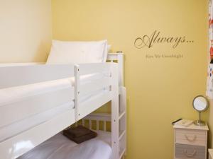 a white bunk bed in a room with a mirror at Rose Cottage in Lofthouse