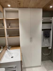 a bathroom with a sink and a white cabinet at VielhaTuca in Betrén