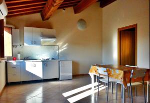 a kitchen with a wooden table and a table and chairs at Villa Magni in Pistoia