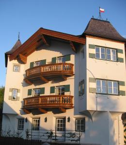 a building with balconies on the side of it at Alpen Glück Schlössl Unterm Rain in Kirchberg in Tirol