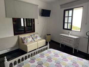 a bedroom with a couch and a bed and a window at Monte del Agua House in Erjos +36 photos