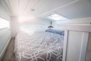 a bedroom with a bed in a small room at Angels Landing Tiny Home in Apple Valley