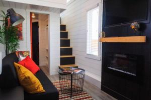 ein Wohnzimmer mit einem Sofa und einem Kamin in der Unterkunft Angels Landing Tiny Home in Apple Valley