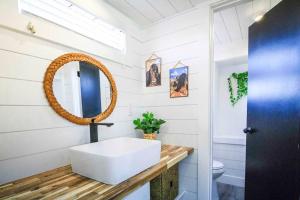 uma casa de banho com um lavatório branco e um espelho. em Angels Landing Tiny Home em Apple Valley