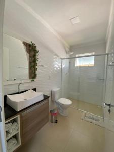 a bathroom with a sink and a toilet at Pousada São Gabriel in Ametista do Sul