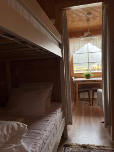 a bedroom with a bed and a window at Rostad Retro Rorbuer in Reine