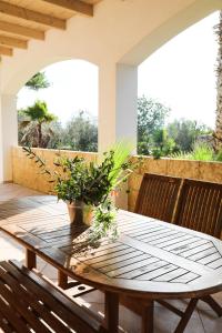 een houten tafel en stoelen op een patio bij Appartamento Villa Nisapiro' Sannicola in Sannicola