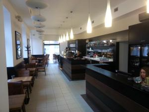 a restaurant with a bar and tables and chairs at Bona Serva in Prague
