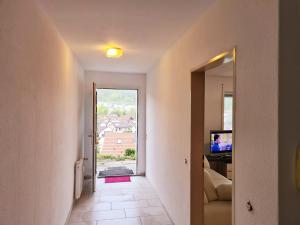 a hallway with a door leading to a room with a window at Seestudio mit toller Aussicht am Bodensee in Bodman-Ludwigshafen