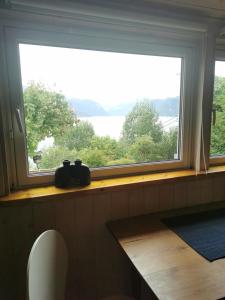 a window in a room with a view of a lake at Stranda apartment in Stranda