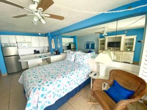 a large bedroom with a bed and a kitchen at Harbour Beach Resort Studios! in Daytona Beach