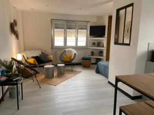 a living room with a couch and a table at Chez Orely in Horbourg