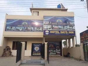 a hotel day inn with signs on the front of it at Hotel Day IN One in Lahore