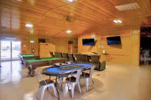 a room with a ping pong table and billards at Ellipse Global Lodge in Carlsbad