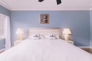 a white bed with two pillows on top of it at LOVELY 3 bedroom PORT MOODY spacious home 6 people free parking in Port Moody +5 photos