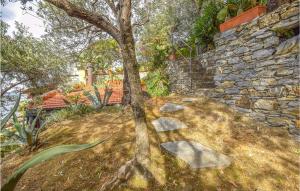 a drawing of a tree in front of a stone wall at Cozy Home In Recco With House Sea View in Recco