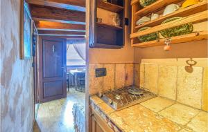a kitchen with a stove and a counter top at Awesome Home In Recco With House Sea View in Recco