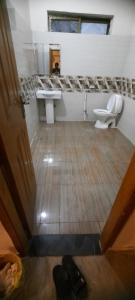 a bathroom with a toilet and a sink at Hotel Day IN One in Lahore +23 photos