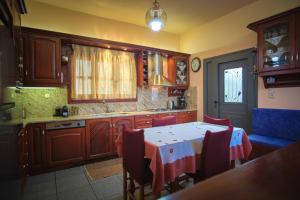 a kitchen with a table with a red and white table cloth at Vretti's House in Kythira