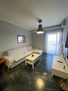 a bedroom with a bed and a table in it at City View Apartment in Mytilini
