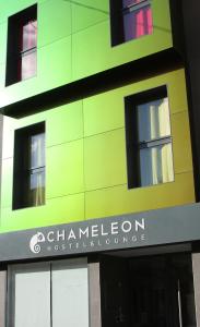 a green building with a sign for a hospital at Chameleon Youth Hostel Alicante in Alicante