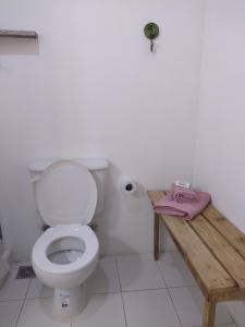 a bathroom with a toilet and a wooden table at Aquí te Espero in Tandil +6 photos