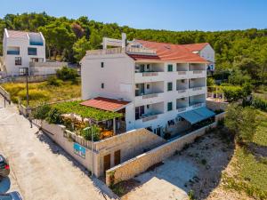 an aerial view of a white house with a red roof at La Perla Apartments in Sutivan