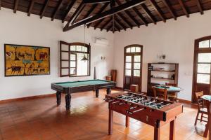 a room with two pool tables in it at Roça Vale dos Prazeres in São Tomé