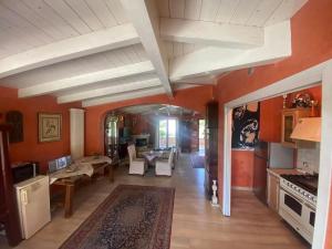 sala de estar con paredes de color naranja y suelo de madera. en B&B Villa Gardasee With Pool, en Soiano del Lago