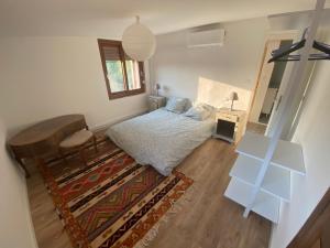 a bedroom with a bed and a table and a mirror at Maison, Centre-ville, 6 lits, terrasse & parking in Apt