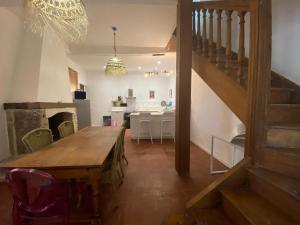 a dining room with a wooden table and a dining room with a fireplace at Maison, Centre-ville, 6 lits, terrasse & parking in Apt
