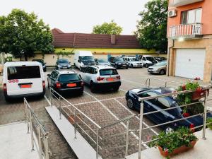 a bunch of cars parked in a parking lot at Pensiune Roua 2 in Arad