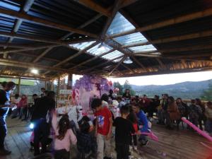 a crowd of people standing in a building with balloons at Glamping Tausavita Ubaté Cundinamarca in El Bujío