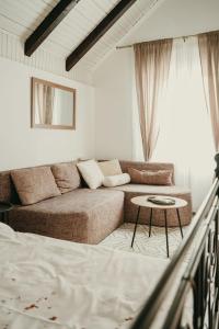 a living room with a couch and a table at Terrazzo house in Subotica
