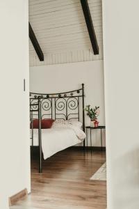 a bedroom with a black bed and a table at Terrazzo house in Subotica +14 photos