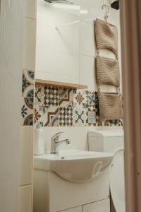 a bathroom with a sink and a mirror at Terrazzo house in Subotica